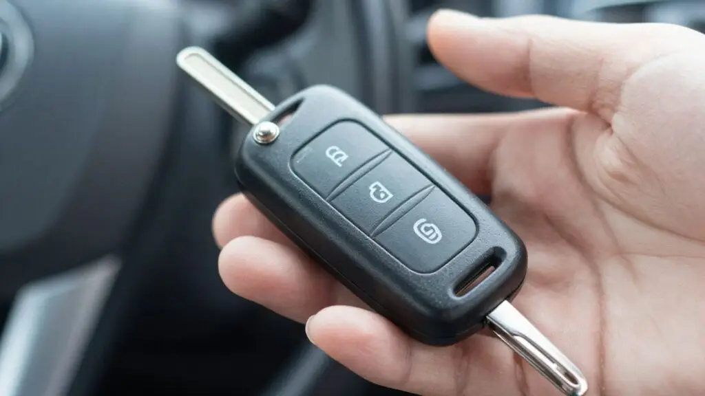 Hand holding a car key fob