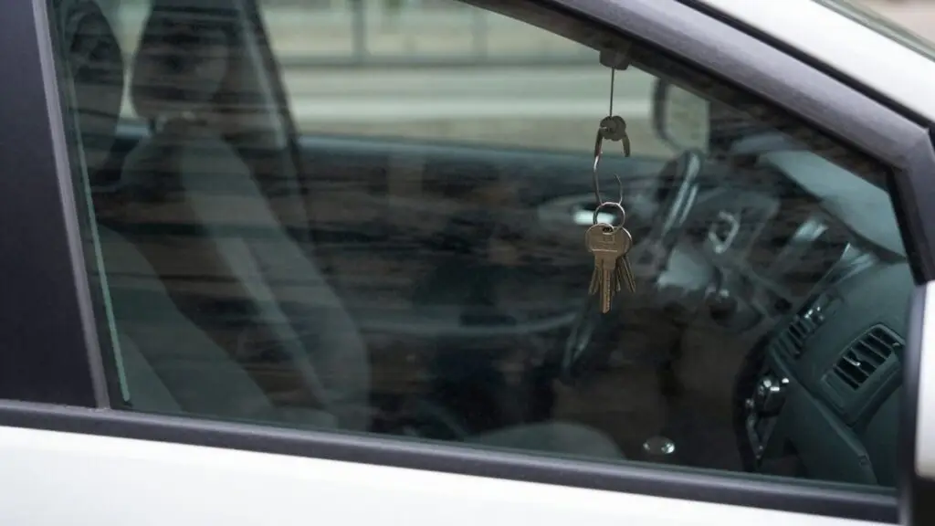 Keys locked inside a car, visible through the window.