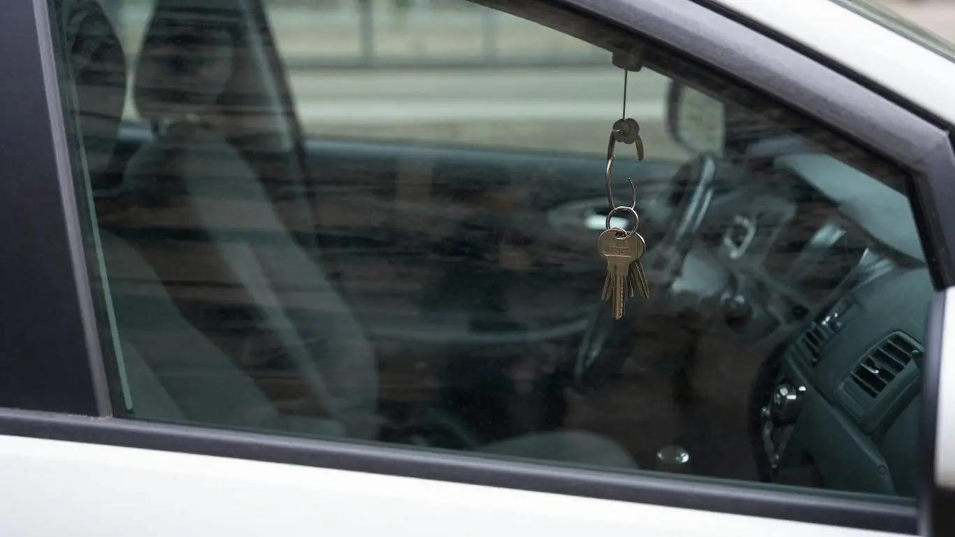 Keys locked inside a car, visible through the window.